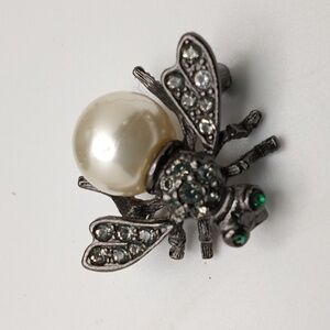 Joan Rivers black bee with rhinestones and pearl.